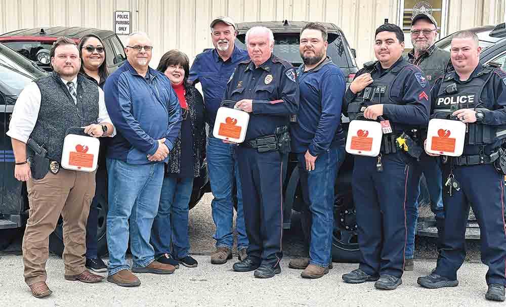 Corrigan Police officers show off the new defibrillators.