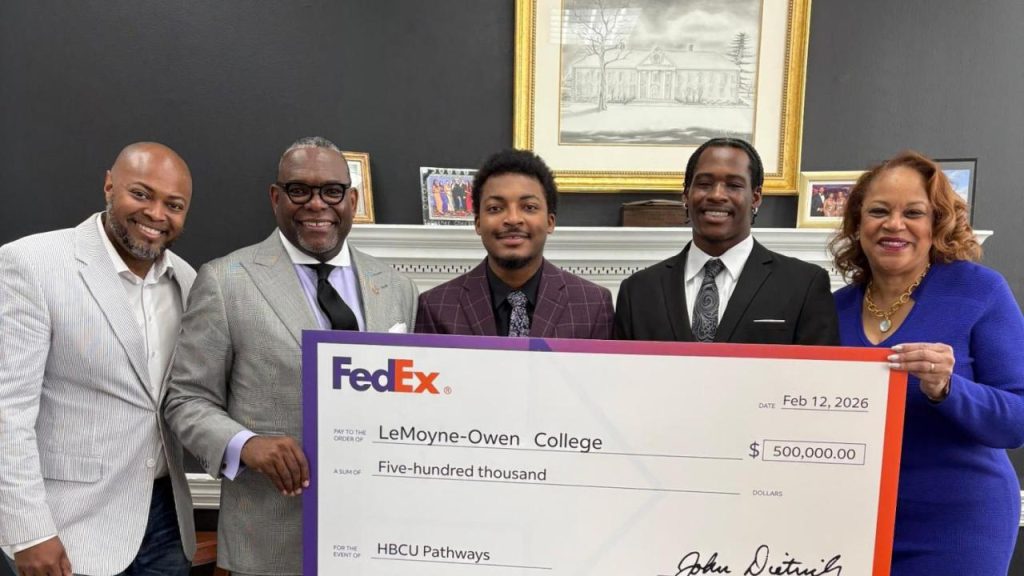 Group holding up a check from FedEx to LeMoyne‑Owen College