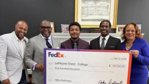 Group holding up a check from FedEx to LeMoyne‑Owen College