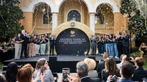 Group photo with confetti in front of Universal School of Experience Leadership and Innovation