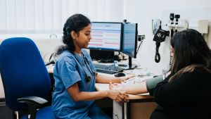 Health care worker taking a patient's blood pressure